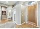 Light-filled entryway with tile floors, a stained wood door, and neutral-colored walls at 20608 N 57Th Ave, Glendale, AZ 85308