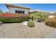 Beautiful desert landscaping with decorative rock, mature plants, and trees at 20608 N 57Th Ave, Glendale, AZ 85308