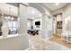 Bright open-concept living space with a game room, dining area, and beige tile flooring at 20608 N 57Th Ave, Glendale, AZ 85308