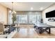 Spacious game room with tile floors, plantation shutters, and a modern light fixture at 20608 N 57Th Ave, Glendale, AZ 85308