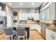 Bright kitchen featuring white cabinets, stainless steel appliances, and a granite countertop island at 20608 N 57Th Ave, Glendale, AZ 85308