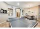 Spacious living area with a ping pong table, dining area, and beautiful tile floors at 20608 N 57Th Ave, Glendale, AZ 85308