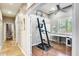 Bright office space with a large desk, ceiling fan, and a treadmill for exercise at 20608 N 57Th Ave, Glendale, AZ 85308