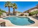 Beautiful backyard pool with palm trees and mature plantings, offering a private oasis at 20608 N 57Th Ave, Glendale, AZ 85308