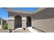 Home entryway featuring an arched entrance, neutral stucco exterior, and tidy desert landscaping at 20838 E Vía De Arboles --, Queen Creek, AZ 85142