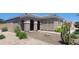 Exterior view of home featuring desert landscaping, an arched entryway, and a mature Saguaro cactus in the yard at 20838 E Vía De Arboles --, Queen Creek, AZ 85142