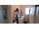 Functional laundry room with modern washer and dryer, ample shelving, and convenient sink for easy chores at 20838 E Vía De Arboles --, Queen Creek, AZ 85142