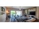 Spacious living room featuring a stone fireplace, media center, and access to the backyard at 20838 E Vía De Arboles --, Queen Creek, AZ 85142