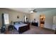 Cozy main bedroom featuring a comfortable bed, dresser, and access to the bathroom at 20838 E Vía De Arboles --, Queen Creek, AZ 85142