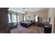 Comfortable main bedroom with ceiling fan, sitting area, and views of the backyard at 20838 E Vía De Arboles --, Queen Creek, AZ 85142