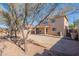 Home showcasing a spacious backyard with a covered patio and neutral colored exterior at 22320 W Morning Glory St, Buckeye, AZ 85326