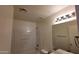 Standard bathroom featuring a shower-tub combo with white fixtures, updated vanity lighting, and neutral decor at 22320 W Morning Glory St, Buckeye, AZ 85326