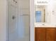 Bathroom showcasing walk-in shower and vanity with oak cabinets at 22320 W Morning Glory St, Buckeye, AZ 85326
