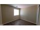 Bedroom features wood-look floors, neutral paint, and a bright window at 22320 W Morning Glory St, Buckeye, AZ 85326