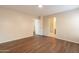 Empty bedroom with wood flooring, light-colored walls, and access to the ensuite at 22320 W Morning Glory St, Buckeye, AZ 85326