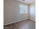 Bedroom featuring a window for natural light and wood-look flooring at 22320 W Morning Glory St, Buckeye, AZ 85326