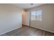 Well-lit bedroom features wood-look flooring and closet for ample storage space at 22320 W Morning Glory St, Buckeye, AZ 85326