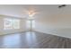 Large bedroom is bright and features wood-look floors and multiple windows at 22320 W Morning Glory St, Buckeye, AZ 85326