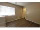 Bedroom featuring wood-look floors, neutral paint, a closet, and a bright window at 22320 W Morning Glory St, Buckeye, AZ 85326