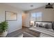 Bedroom with ample light, simple decor, and a walk-in closet adjacent to the bathroom at 22320 W Morning Glory St, Buckeye, AZ 85326