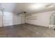 Spacious garage with a large door, concrete floors, and ample storage space at 22320 W Morning Glory St, Buckeye, AZ 85326