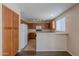 Functional kitchen with oak cabinets, white appliances, and an breakfast bar, creating a practical cooking space at 22320 W Morning Glory St, Buckeye, AZ 85326