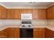 Efficient kitchen with oak cabinets, white appliances, and ample countertop space for food preparation and cooking at 22320 W Morning Glory St, Buckeye, AZ 85326