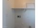 Utility area with white walls, washer/dryer hookups, shelf, and electrical outlets at 22320 W Morning Glory St, Buckeye, AZ 85326