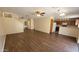 Open-concept living room and kitchen area with attractive wood-look floors and neutral paint at 22320 W Morning Glory St, Buckeye, AZ 85326