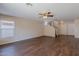 Unstaged living room with light walls, wood flooring, and access to the second floor at 22320 W Morning Glory St, Buckeye, AZ 85326