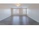 Unstaged living room with wood floors and large windows providing ample natural light at 22320 W Morning Glory St, Buckeye, AZ 85326