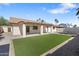 The backyard features artificial turf, a covered patio, and desert landscaping for easy maintenance at 2329 S Elm --, Mesa, AZ 85202