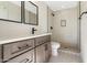 Bathroom featuring modern vanity, matte black fixtures, and a sleek glass-enclosed shower at 2329 S Elm --, Mesa, AZ 85202