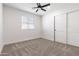 A spacious bedroom featuring sliding closet doors and a modern ceiling fan at 2329 S Elm --, Mesa, AZ 85202