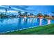 Tranquil lake with a beautiful fountain and evening lights, creating a serene community ambiance at 2329 S Elm --, Mesa, AZ 85202