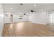 Bright living area with new floors, updated lighting, and ceiling fans adjacent to the entry at 2329 S Elm --, Mesa, AZ 85202