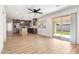 Open-concept living space featuring new flooring, abundant light, ceiling fans, and kitchen access at 2329 S Elm --, Mesa, AZ 85202