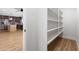 Walk-in pantry featuring ample white shelving offering plenty of storage space in the kitchen at 2329 S Elm --, Mesa, AZ 85202
