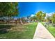 Charming community playground with modern equipment, lush landscaping, and a peaceful seating area at 2329 S Elm --, Mesa, AZ 85202