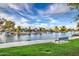 Scenic waterfront view with lush landscaping, community lake, and inviting bench seating at 2329 S Elm --, Mesa, AZ 85202