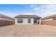 The backyard offers ample space with the house and patio perfect for entertaining or quiet relaxation at 23385 W Burton Ave, Buckeye, AZ 85326
