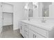 Modern bathroom features double sinks, sleek white cabinetry, and a spacious walk-in shower, perfect for a contemporary lifestyle at 23385 W Burton Ave, Buckeye, AZ 85326