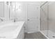 Bathroom featuring a walk-in shower with glass door, modern fixtures, and plenty of natural light at 23385 W Burton Ave, Buckeye, AZ 85326