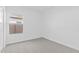 An unfurnished bedroom with neutral carpeting, white walls, and natural light from a window at 23385 W Burton Ave, Buckeye, AZ 85326
