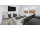 Bright bedroom with large windows, TV, and stylish decor for a modern and comfortable living space at 23385 W Burton Ave, Buckeye, AZ 85326