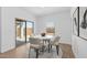 Bright dining area with a sliding glass door leading to the patio and modern decor at 23385 W Burton Ave, Buckeye, AZ 85326