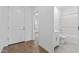 Clean entryway with wood flooring, a view of the bathroom, and a glimpse into another room at 23385 W Burton Ave, Buckeye, AZ 85326