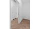 Hallway with tiled floors leading to a door and a spacious interior, all freshly painted white at 23385 W Burton Ave, Buckeye, AZ 85326