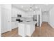 Bright kitchen featuring white cabinets, quartz countertops, stainless steel appliances, and a center island at 23385 W Burton Ave, Buckeye, AZ 85326