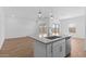 Sunlit kitchen island with a stainless steel sink, and fixtures; open concept with great light at 23385 W Burton Ave, Buckeye, AZ 85326